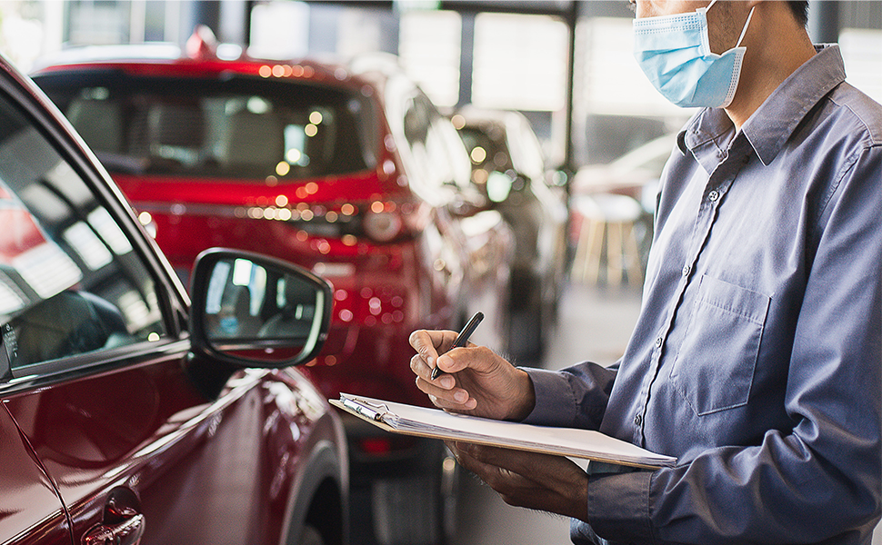 An image of a masked man conducting drive-through COVID-19 tests