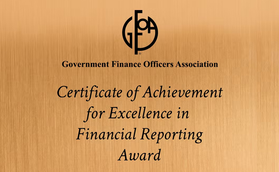 A certificate reading "Certificate of Achievement for Excellence in Financial Reporting Award" issued by the GFOA