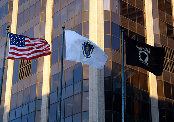 The John W. McCormack Building (One Ashburton Place, Boston), with the American Flag, Massachusetts flag, and POW-MIA flag in the foreground