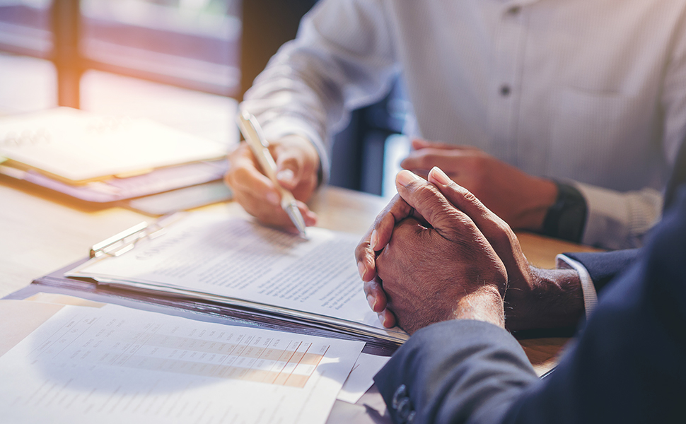 An image of two people executing a contract agreement