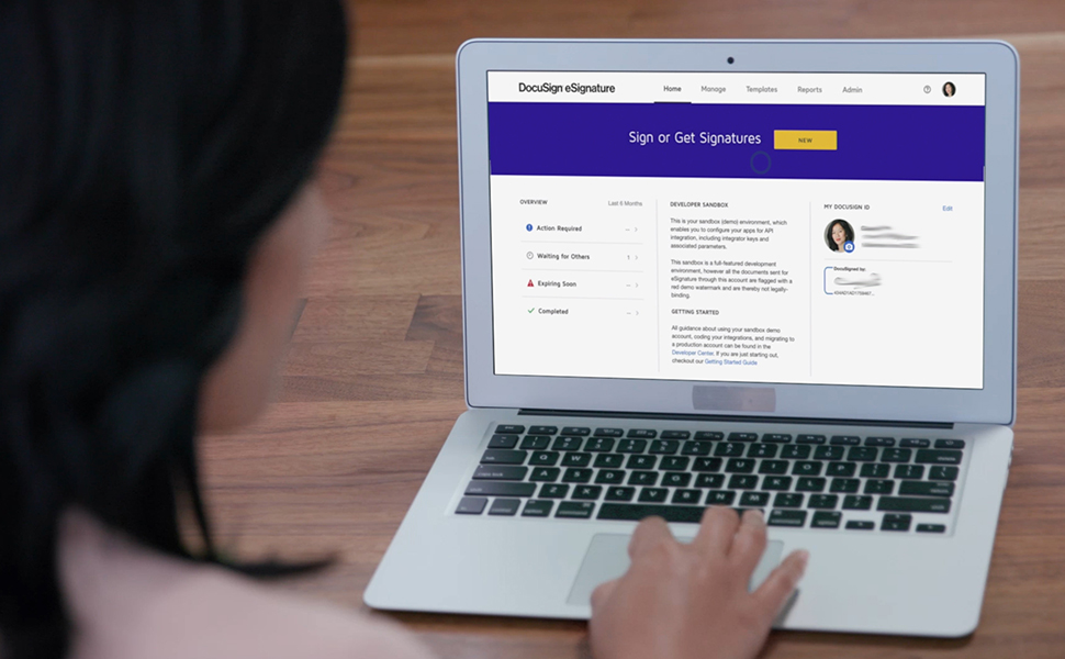 An image of a woman using DocuSign on her laptop